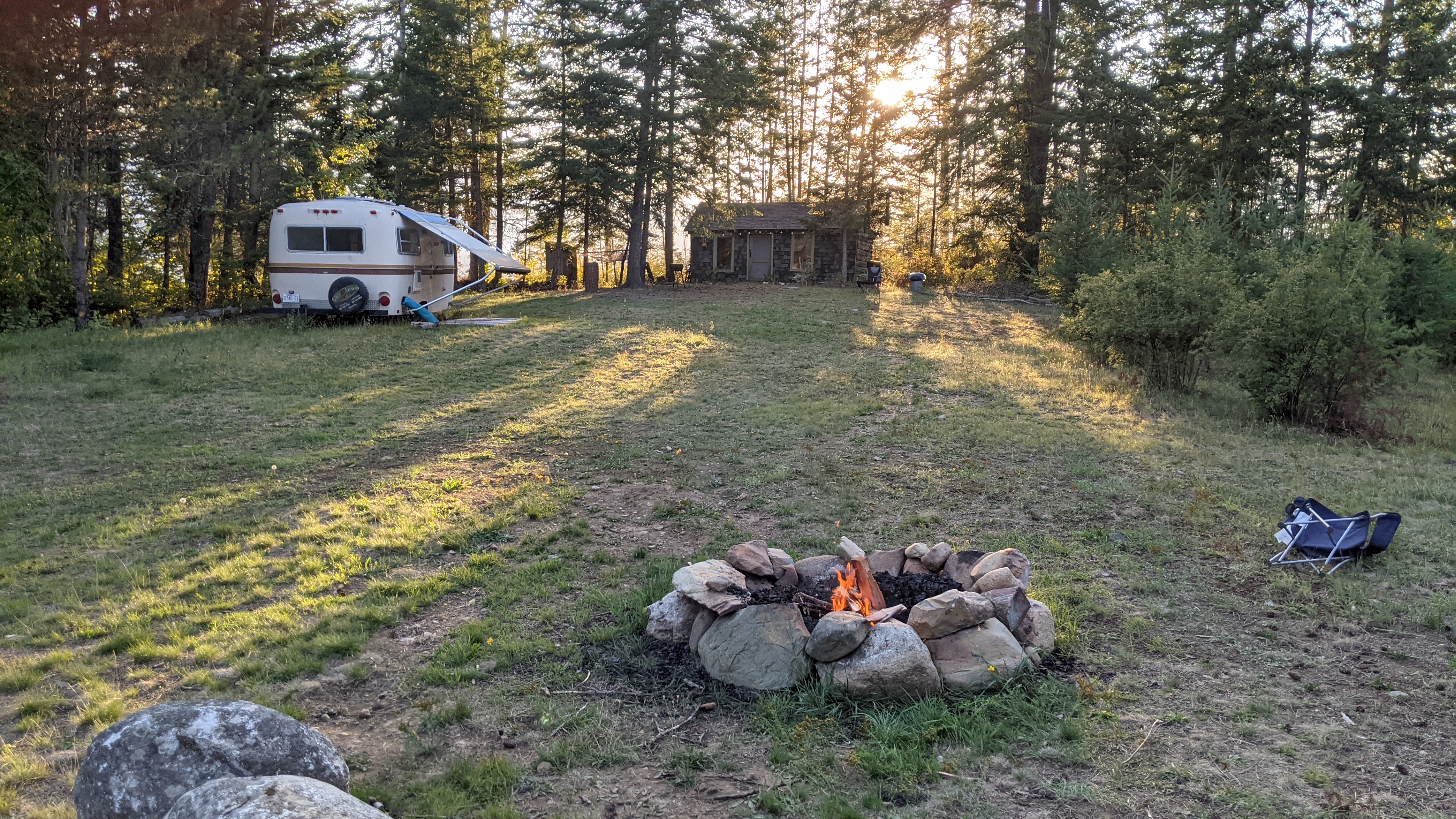 Shot across the field captures fire boler cabin
